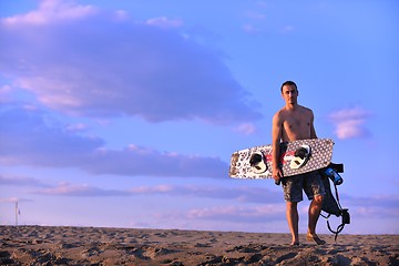 Image showing Portrait of a young  kitsurf  man at beach on sunset