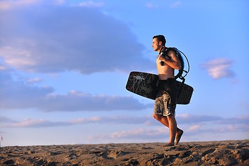 Image showing Portrait of a young  kitsurf  man at beach on sunset