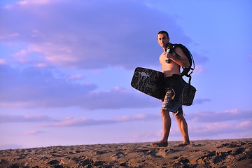 Image showing Portrait of a young  kitsurf  man at beach on sunset