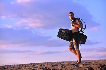 Image showing Portrait of a young  kitsurf  man at beach on sunset