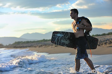 Image showing Portrait of a young  kitsurf  man at beach on sunset