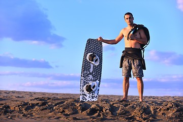 Image showing Portrait of a young  kitsurf  man at beach on sunset