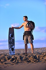 Image showing Portrait of a young  kitsurf  man at beach on sunset