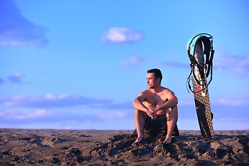 Image showing Portrait of a young  kitsurf  man at beach on sunset