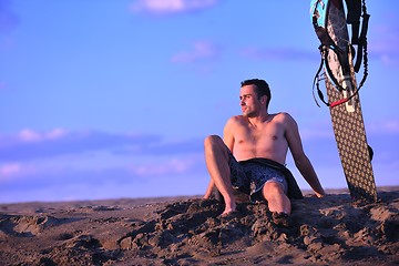 Image showing Portrait of a young  kitsurf  man at beach on sunset