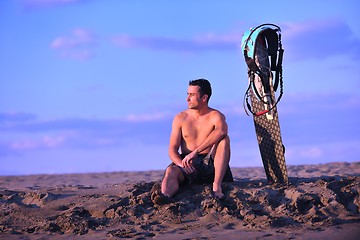 Image showing Portrait of a young  kitsurf  man at beach on sunset