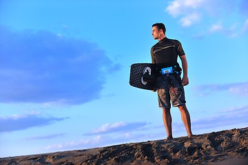 Image showing Portrait of a young  kitsurf  man at beach on sunset