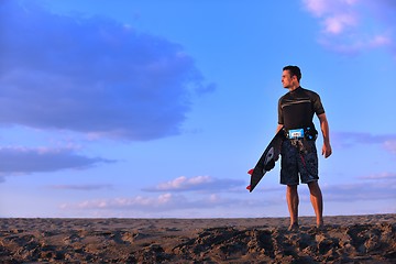 Image showing Portrait of a young  kitsurf  man at beach on sunset