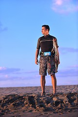 Image showing Portrait of a young  kitsurf  man at beach on sunset