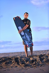 Image showing Portrait of a young  kitsurf  man at beach on sunset