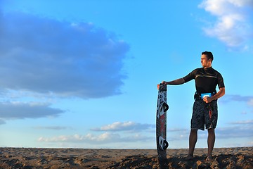 Image showing Portrait of a young  kitsurf  man at beach on sunset