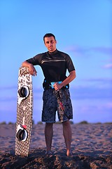 Image showing Portrait of a young  kitsurf  man at beach on sunset