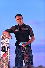 Image showing Portrait of a young  kitsurf  man at beach on sunset