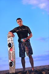 Image showing Portrait of a young  kitsurf  man at beach on sunset