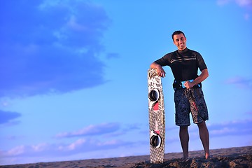 Image showing Portrait of a young  kitsurf  man at beach on sunset