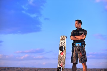 Image showing Portrait of a young  kitsurf  man at beach on sunset