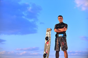 Image showing Portrait of a young  kitsurf  man at beach on sunset