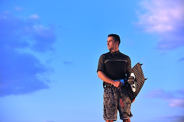 Image showing Portrait of a young  kitsurf  man at beach on sunset