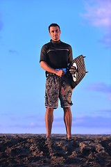 Image showing Portrait of a young  kitsurf  man at beach on sunset