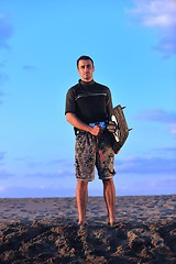 Image showing Portrait of a young  kitsurf  man at beach on sunset