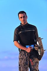 Image showing Portrait of a young  kitsurf  man at beach on sunset