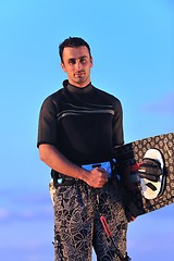 Image showing Portrait of a young  kitsurf  man at beach on sunset