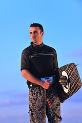 Image showing Portrait of a young  kitsurf  man at beach on sunset