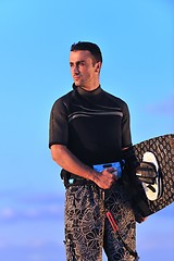 Image showing Portrait of a young  kitsurf  man at beach on sunset