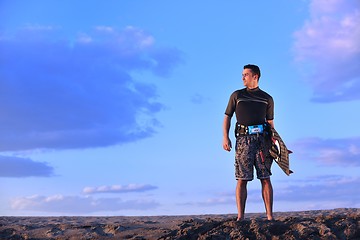 Image showing Portrait of a young  kitsurf  man at beach on sunset