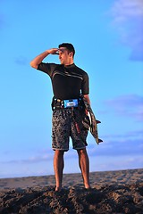 Image showing Portrait of a young  kitsurf  man at beach on sunset