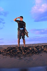 Image showing Portrait of a young  kitsurf  man at beach on sunset