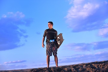 Image showing Portrait of a young  kitsurf  man at beach on sunset