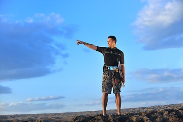 Image showing Portrait of a young  kitsurf  man at beach on sunset