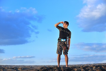 Image showing Portrait of a young  kitsurf  man at beach on sunset