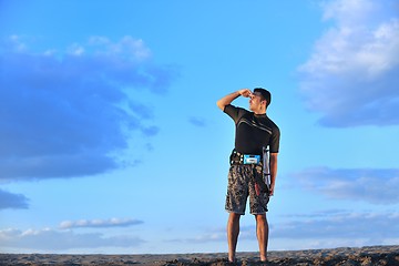 Image showing Portrait of a young  kitsurf  man at beach on sunset