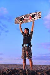 Image showing Portrait of a young  kitsurf  man at beach on sunset