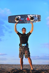 Image showing Portrait of a young  kitsurf  man at beach on sunset