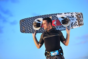 Image showing Portrait of a young  kitsurf  man at beach on sunset