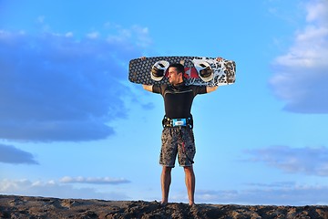 Image showing Portrait of a young  kitsurf  man at beach on sunset