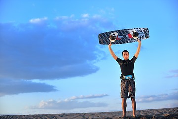 Image showing Portrait of a young  kitsurf  man at beach on sunset