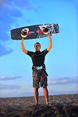 Image showing Portrait of a young  kitsurf  man at beach on sunset