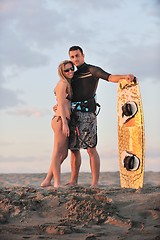 Image showing surf couple posing at beach on sunset