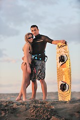 Image showing surf couple posing at beach on sunset