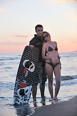 Image showing surf couple posing at beach on sunset