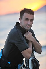 Image showing Portrait of a young  kitsurf  man at beach on sunset