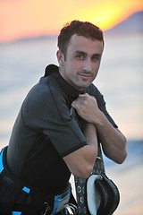 Image showing Portrait of a young  kitsurf  man at beach on sunset