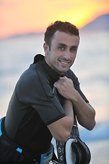 Image showing Portrait of a young  kitsurf  man at beach on sunset