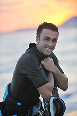Image showing Portrait of a young  kitsurf  man at beach on sunset