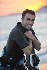 Image showing Portrait of a young  kitsurf  man at beach on sunset