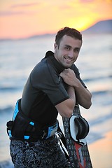 Image showing Portrait of a young  kitsurf  man at beach on sunset